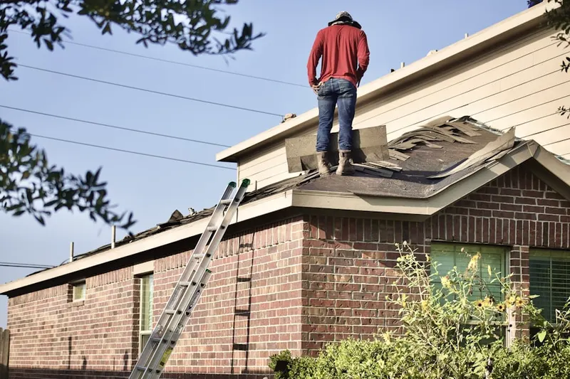 Professional roofer working on a residential roof in Richmond West